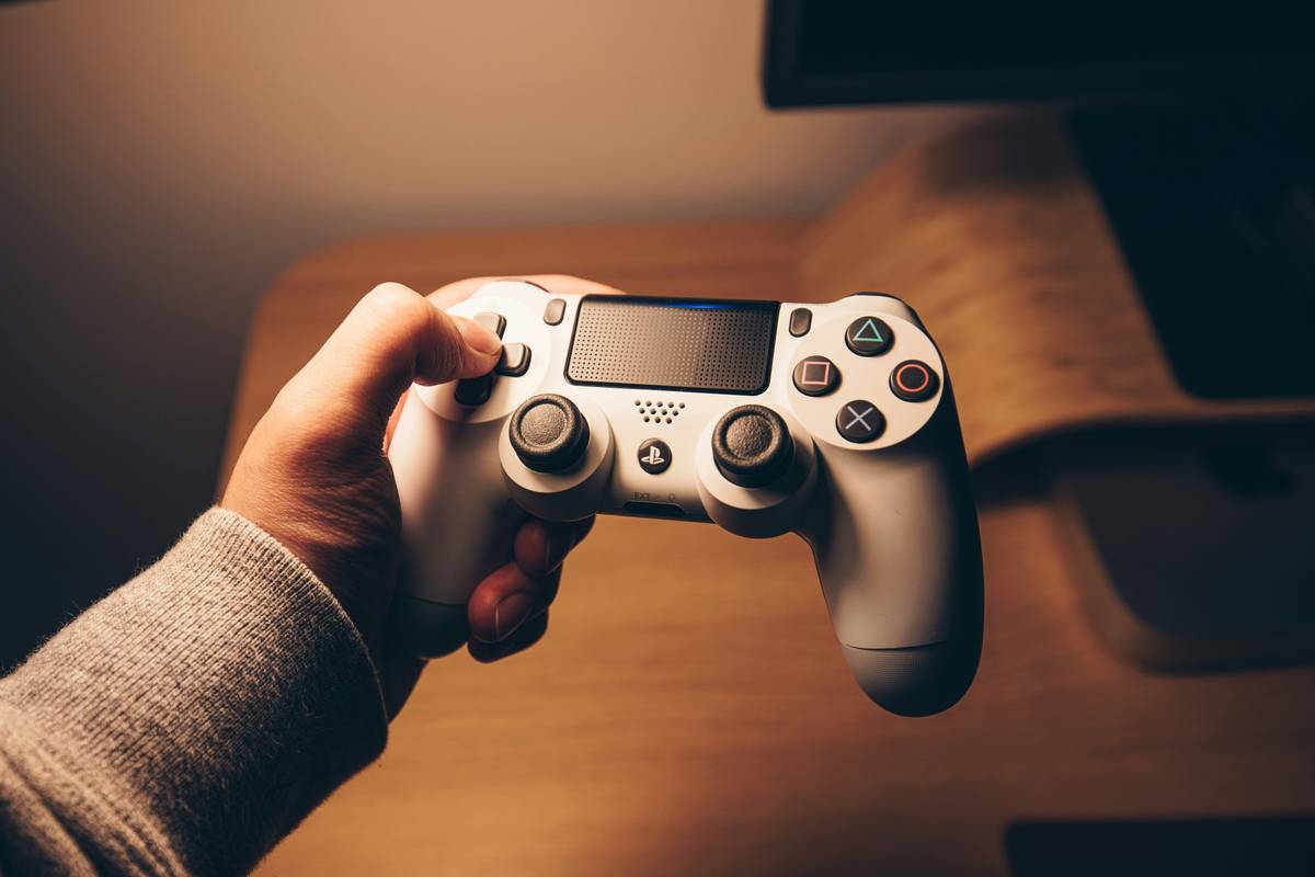 close-up of game ps4 controller wireless showing reset button location and light bar status